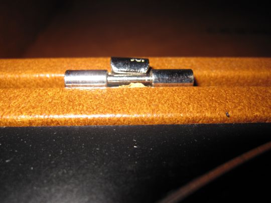 Close up photo shows a bent hinge connecting the turntable to its cover.