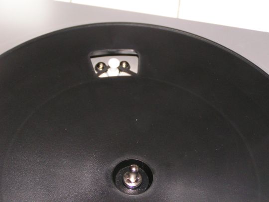 Photos shows belt around a pulley through a hole in the bare turntable platter on the Ion Audio TTUSB05.