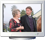A photo of a young man and older woman is seen on the screen of a computer monitor illustration.