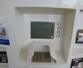 Photo of an ARCO 'PayQuick' station, accepting cash and debit cards to buy gas.