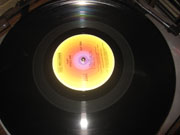 Photo of Crosley, case open, showing the platter, tonearm and controls.