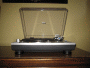 Photo shows the Audio-Technica AT-LP120-USB from the front. The platter and controls emerge from the eye-level platform.