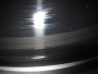 Close-up photo shows a black record with a gray ring starting from the outer edge and continuing through the first track. Damage was from a defective stylus on a Grace Digital Audio Vinylwriter (AVPUSB01S) USB turntable.